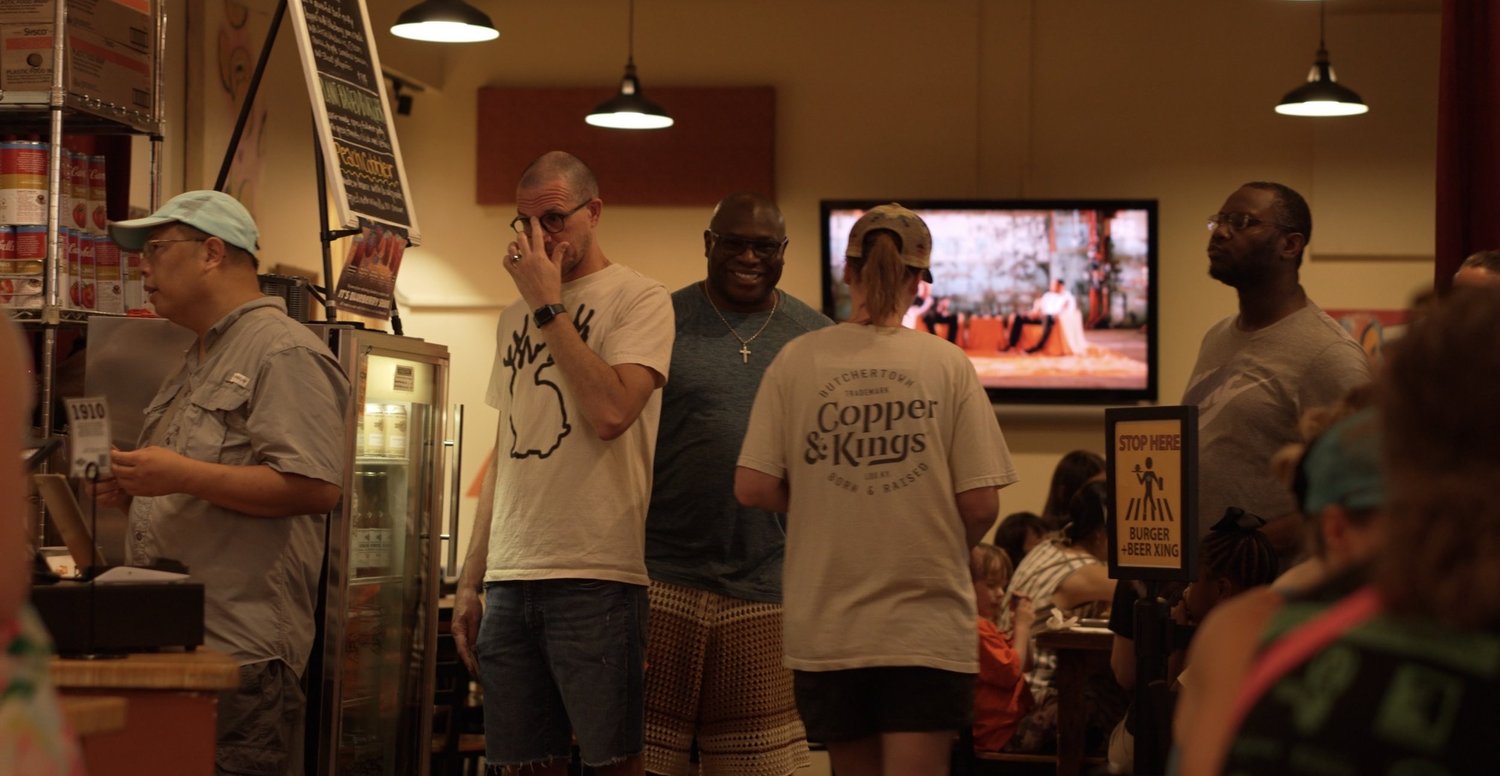 Neighbors sharing a conversation inside a Durham restaurant